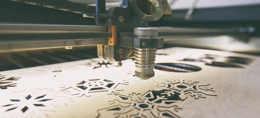 Laser cutting machine is cutting the wooden plank